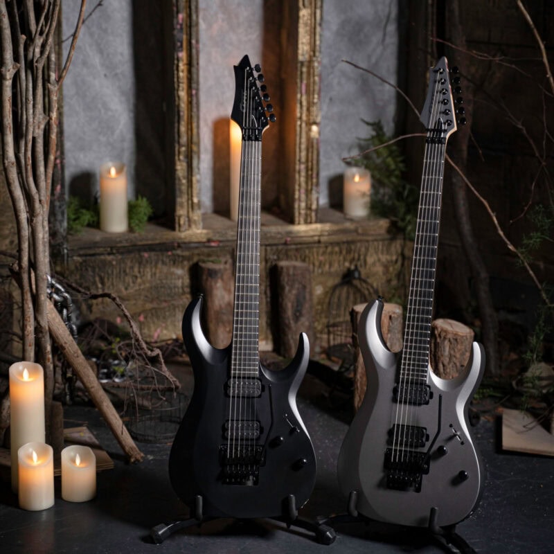 Black and silver electric guitars in a dimly lit, rustic setting with candles and wooden décor, perfect for music lovers and musicians shopping at The Music Outlet in Swords, Dublin.