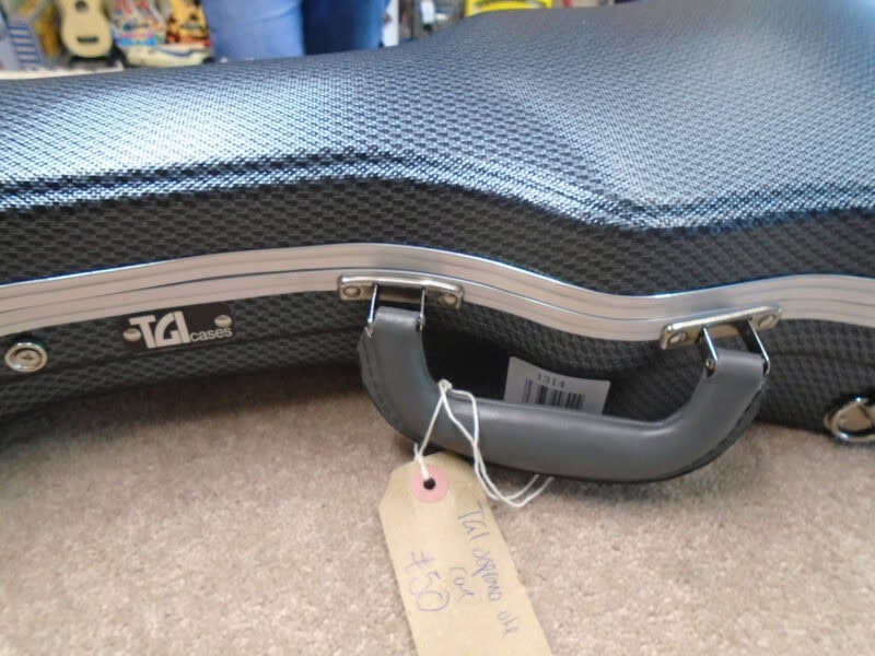 Soft case for guitar, black textured material with silver accents and handle, suitable for protecting and transporting musical instruments, available at The Music Outlet Dublin.
